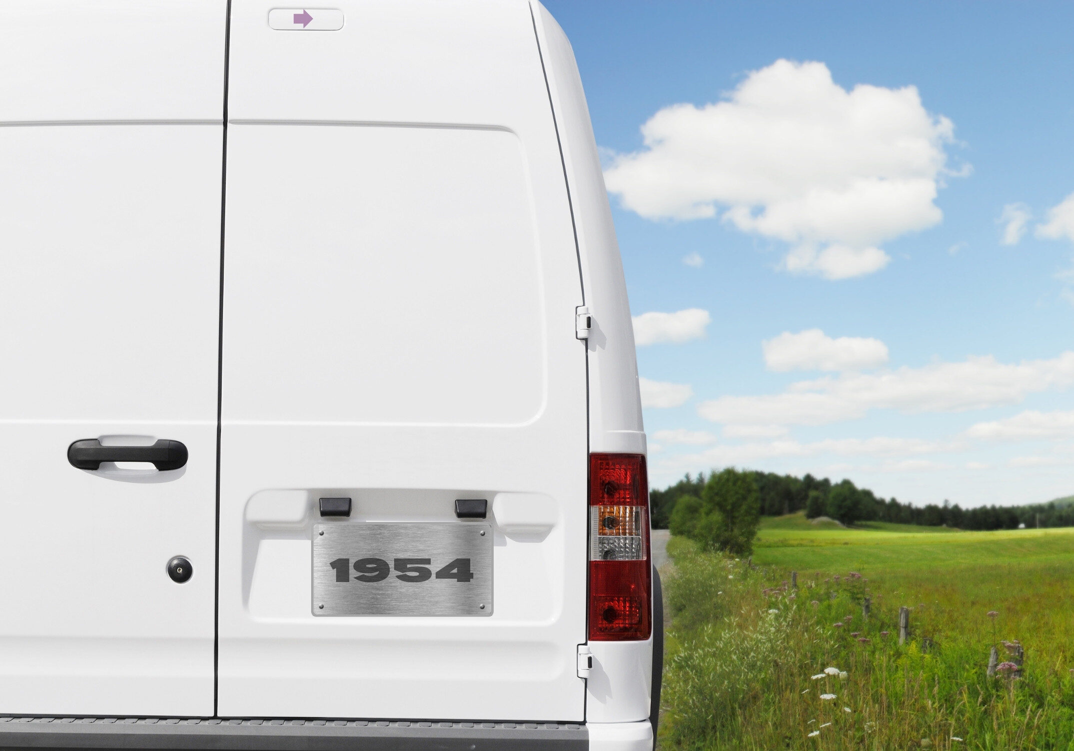 Image of back of delivery van with 1954 steel license plate