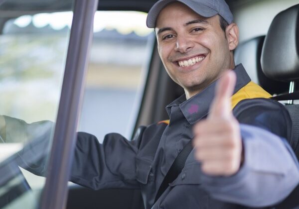 Image of delivery driver smiling with thumbs-up.